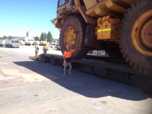 Heavy dump truck on low loader
